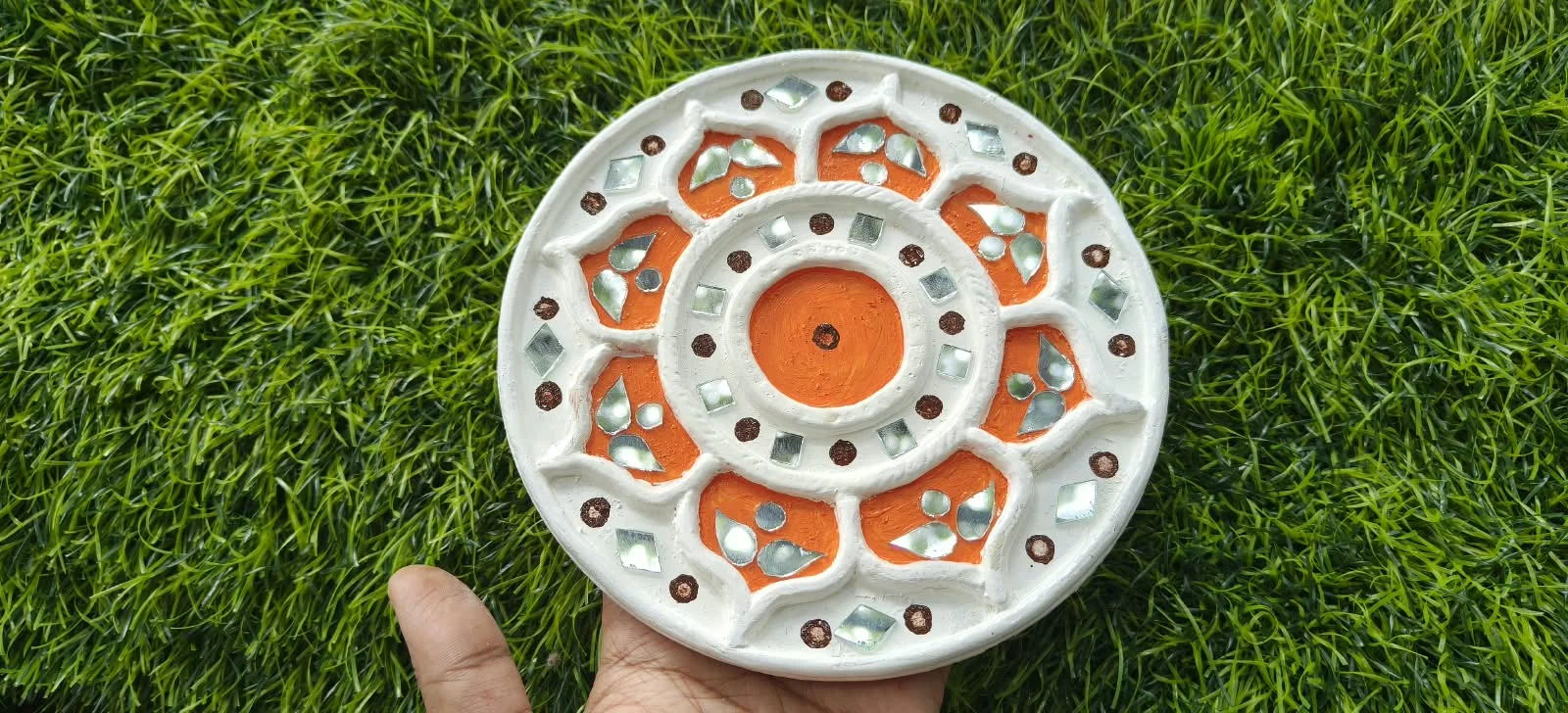 Handmade circular Lippan art, orange bloom design